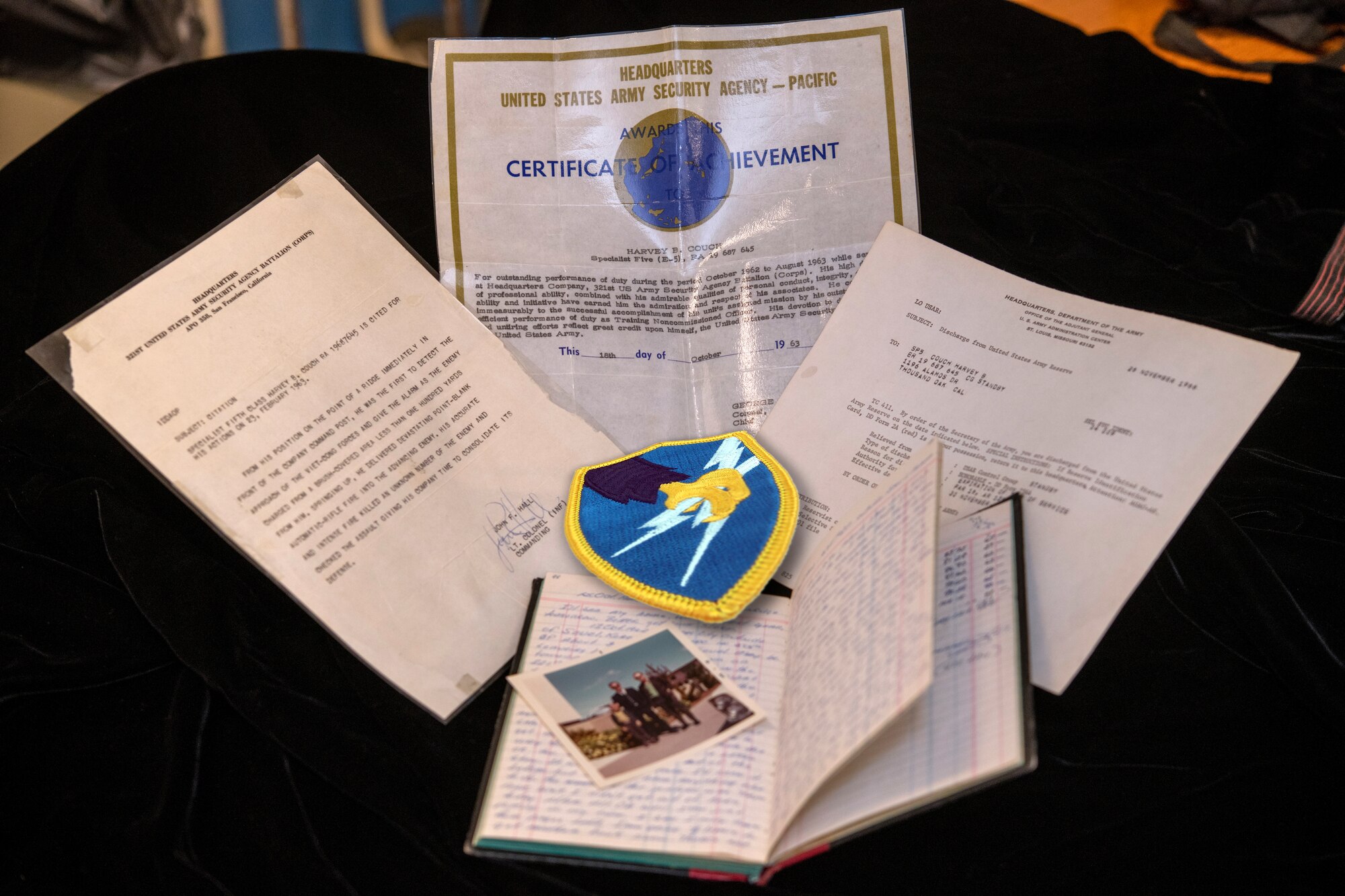 Historical documents and memorabilia belonging to Specialist 5th Class Harvey Couch are displayed