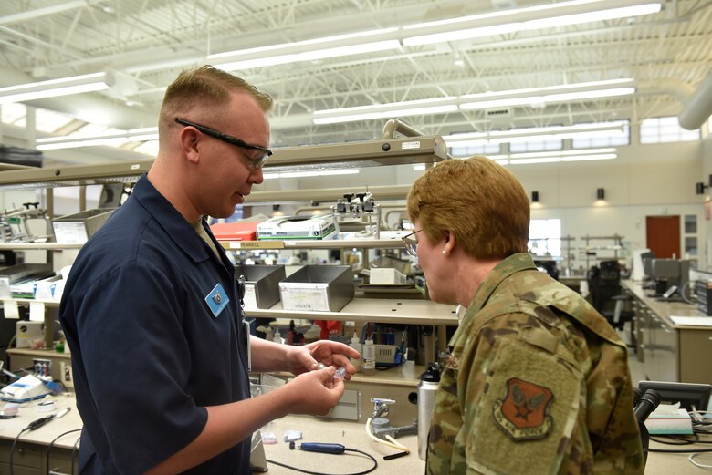 Lt. Gen. Dorothy Hogg, U.S. Air Force Surgeon General, looks over work done by Staff Sgt. Samuel Pennell, 21st Operational Medical Readiness Squadron dental laboratory technician, at the Area Dental Laboratory on Peterson Air Force Base, Colorado, Nov. 1, 2019. The Peterson dental lab creates night guards, retainers, and dental implants for members across the Air Force. (U.S. Air Force photo by Airman Alexis Christian)