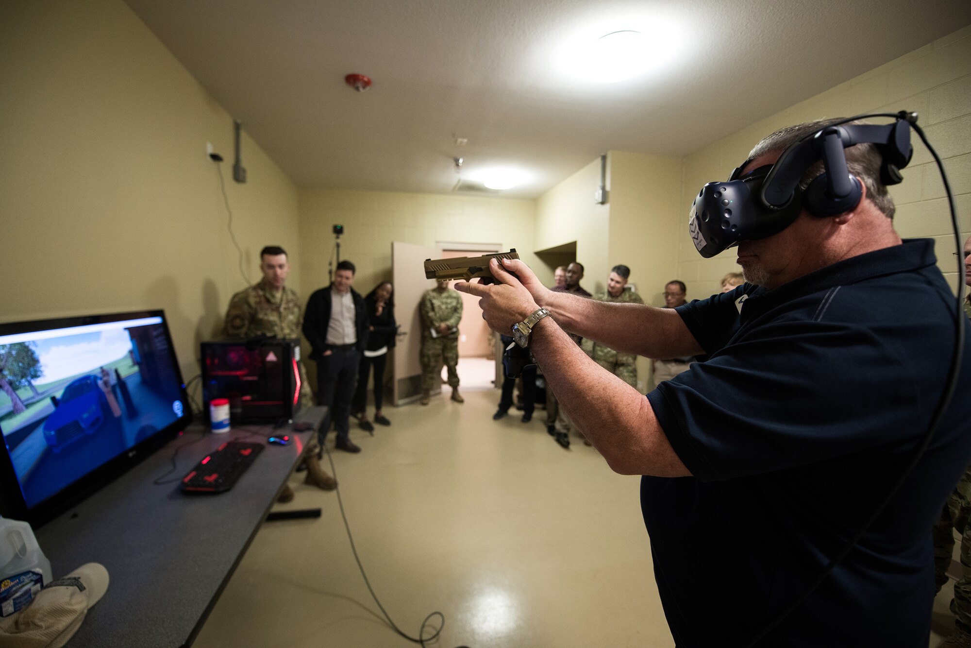 Civic leader David Radcliffe (right), President of the Radcliffe Group, Keller Williams Realty Southwest, tries a virtual reality simulator at the Security Forces mock Air Base and firearms simulators building, Nov. 7, 2019, at Joint Base San Antonio-Medina Annex, Texas