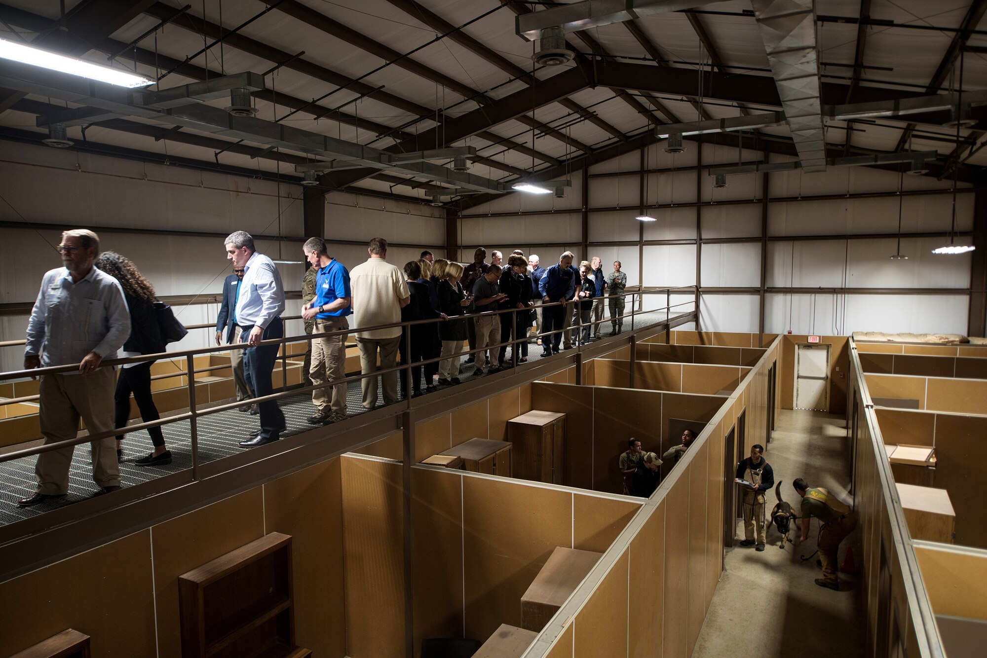 Civic leaders watch a K9 room search demonstration at the 341st Training Squadron military working dog compound, Nov. 7, 2019, at Joint Base San Antonio-Medina Annex, Texas.