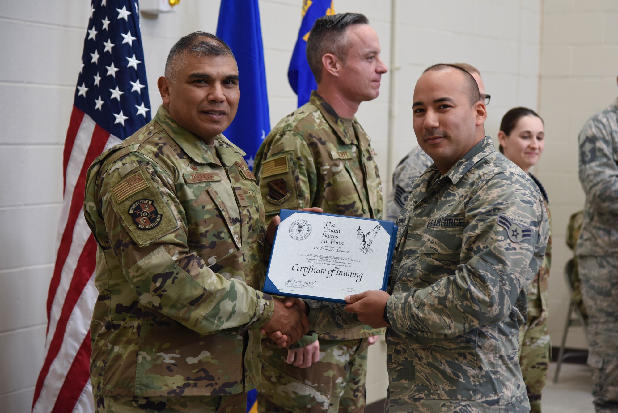 Col. Anthony Puente, 982nd Training Group commander, presents Airman 1st Class Francisco Ramirez, 22nd Maintenance Squadron crew chief, with a Certificate of Training during the Mission Ready Airmen program graduation Nov. 5, 2019, at McConnell Air Force Base, Kan. The Mission ready Airmen program allows Airmen to have a deeper understanding and knowledge of the KC-46 Pegasus before reaching their respective units. (U.S. Air Force photo by Airman 1st Class Marc A. Garcia)