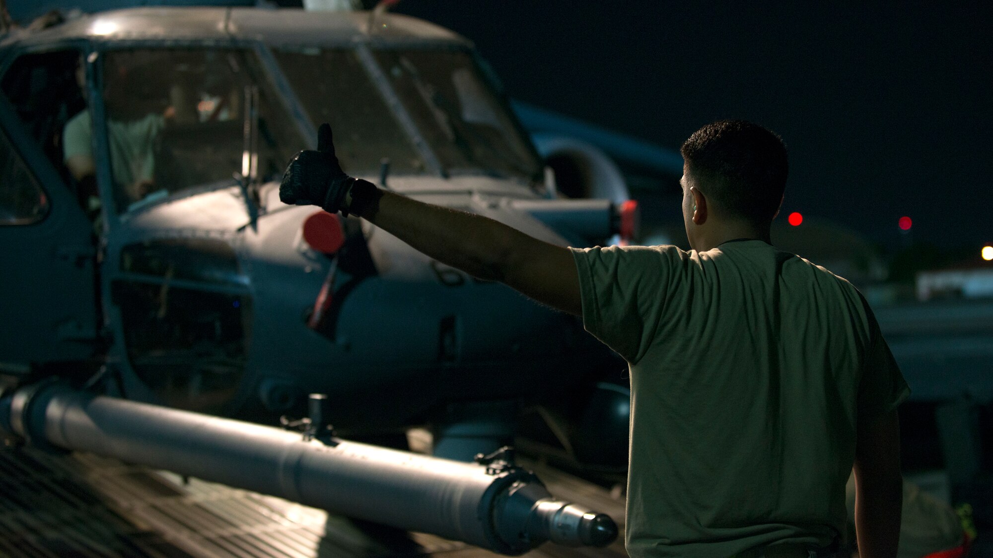 A U.S. Air Force Airman directs the unloading of an HH-60 Pave Hawk helicopter assigned to the 305th Rescue Squadron, Davis-Monthan Air Force Base, Ariz., from a C-5 Super Galaxy assigned to the 512th Airlift Wing, Dover Air Force Base, Del., at MacDill Air Force Base, Fla., Nov. 6, 2019.