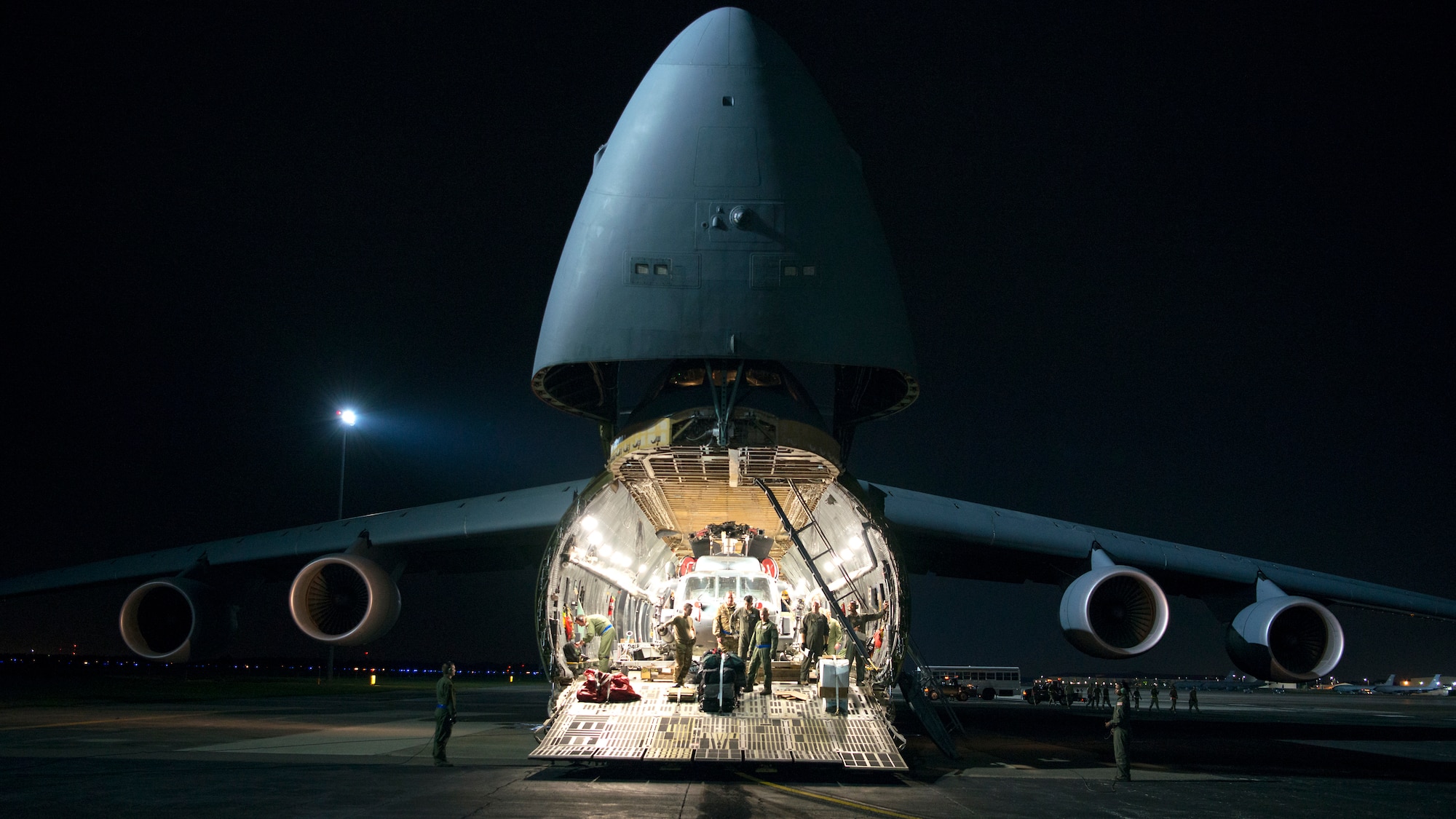Aircrew prepare to unload an HH-60 Pave Hawk helicopter assigned to the 305th Rescue Squadron, Davis-Monthan Air Force Base, Ariz., from a C-5 Super Galaxy assigned to Dover Air Force Base, Del., at MacDill Air Force Base, Fla., Nov. 6, 2019.