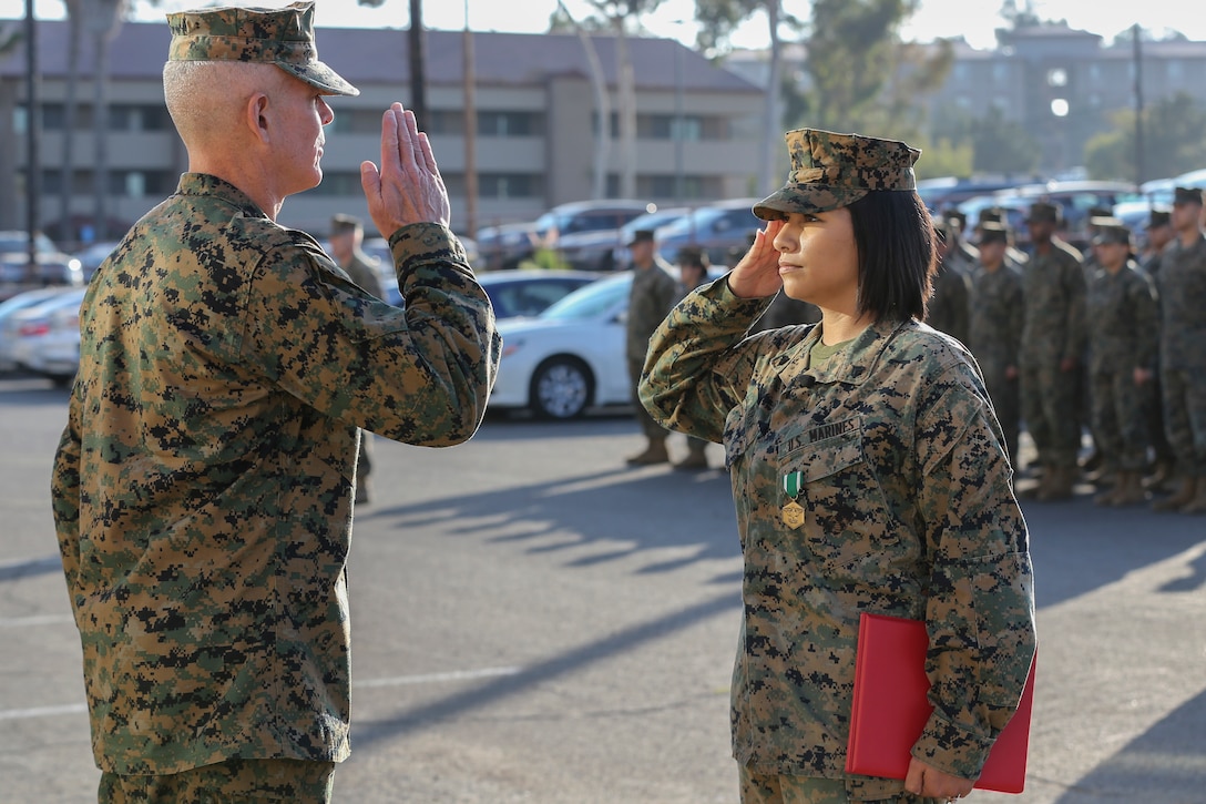 U.S. Marine Cpl. Alexandra Nowak, an administrative specialist with Alpha Company, Headquarters and Support Battalion, Marine Corps Installations West, Marine Corps Base Camp Pendleton, salutes Brig. Gen. Dan Conley, the commanding general of Marine Corps Installations West, Marine Corps Base Camp Pendleton, after being awarded the Navy and Marine Corps Commendation Medal during an award ceremony on Camp Pendleton, California, Nov. 6, 2019. Nowak received the award for her actions to save a family after a car crash on Interstate Highway 15. Nowak is a native of Forney, Texas.