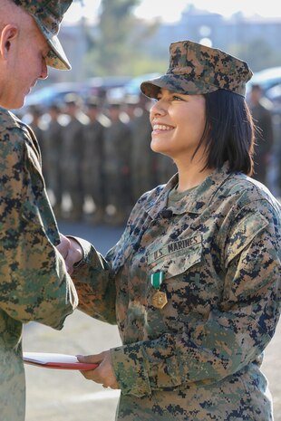 U.S. Marine Cpl. Alexandra Nowak, an administrative specialist with Alpha Company, Headquarters and Support Battalion, Marine Corps Installations West, Marine Corps Base Camp Pendleton, receives a Navy and Marine Corps Commendation Medal from by Brig. Gen. Dan Conley, the commanding general for MCI-West, MCB Camp Pendleton, during an award ceremony on Camp Pendleton, California, Nov. 6, 2019. Nowak received the award for her actions to save a family after a car crash on Interstate Highway 15. Nowak is a native of Forney, Texas.