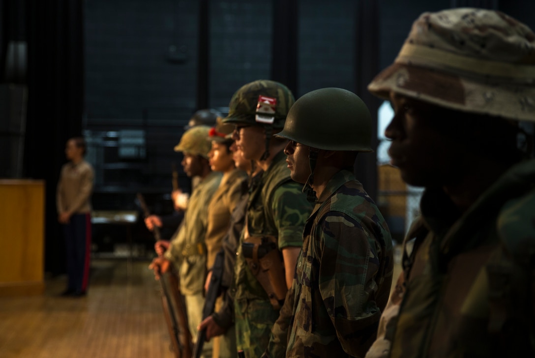 U.S. Marines dressed in historic uniforms stand at parade rest during a Historic Uniform Pageant at Grover C. Fields Middle School in New Bern, North Carolina, Nov. 6, 2019. This pageant featured Marines dressed in Marine Corps uniforms from the American Revolutionary War to Operation Desert Storm. This pageant allows students a first-hand look into Marine Corps history and how America’s premier fighting force fought their wars. (U.S. Marine Corps photo by Lance Cpl. Jacob Bertram)