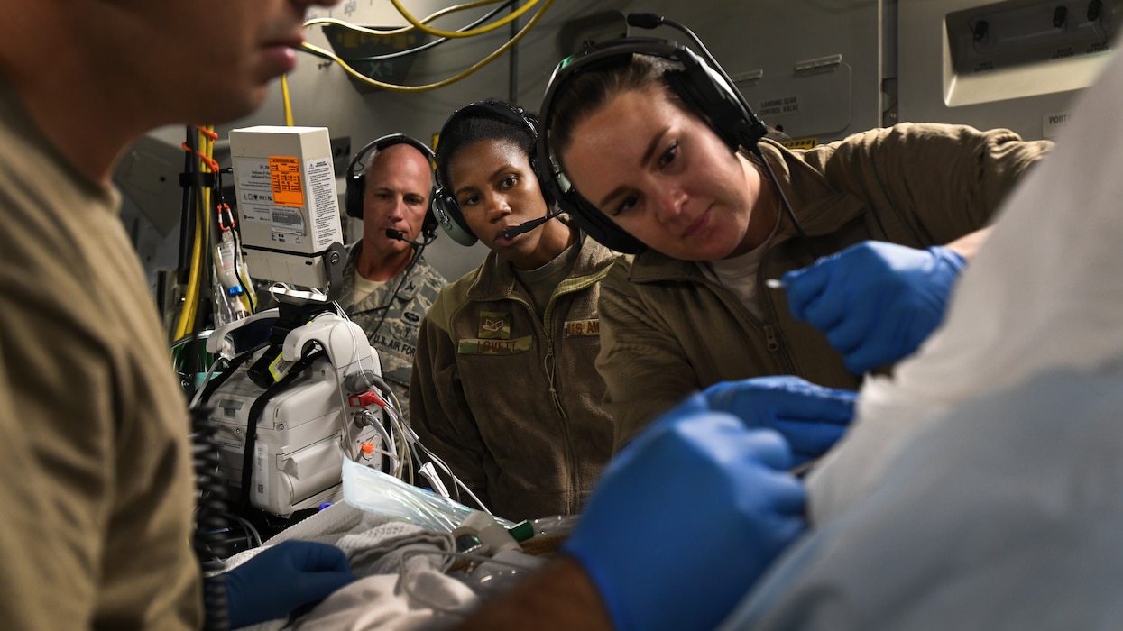 A critical care air transport team tends to a patient during a 20-hour direct flight from Bagram Airfield, Afghanistan, to San Antonio, Texas, Aug. 18, 2019. The service member was cared for by a joint service team of extracorporeal membrane oxygenation specialists, an aeromedical evacuation team as well as CCATT in order to maintain the highest level of care possible during transport. (U.S. Air Force photo by Airman 1st Class Ryan Mancuso)