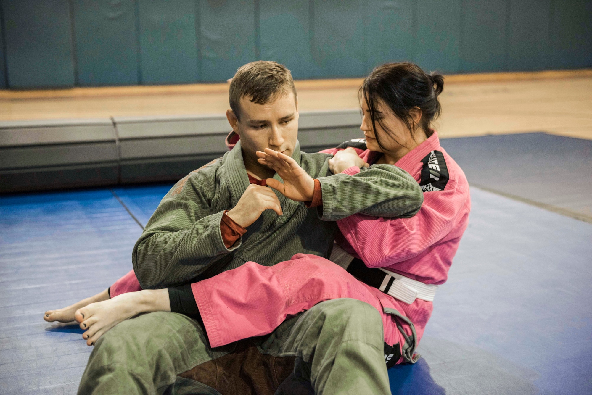 U.S. Air Force Staff Sgt. Christian Brancato, a Brazilian Jiu-Jitsu coach, teaches ground fighting techniques to Staff Sgt. Dani Acevedo, a student, during a class Nov. 7, 2019, at Incirlik Air Base, Turkey. Brazilian Jiu-Jitsu serves as a major component of mixed-martial arts, and is one of the many free fitness-related classes offered to Airmen on the installation. (U.S. Air Force photo by Staff Sgt. Joshua Magbanua)