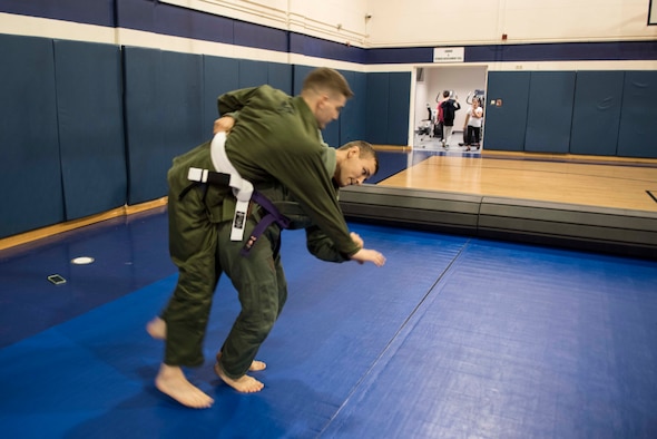 U.S. Air Force Staff Sgt. Christian Brancato, a Brazilian Jiu-Jitsu coach, flips Senior Airman Steven Nadeau, a student, during a class Nov. 7, 2019, at Incirlik Air Base, Turkey. The free class is conducted by Airmen who volunteer to teach as BJJ coaches, and is available for all Airmen stationed on the installation. (U.S. Air Force photo by Staff Sgt. Joshua Magbanua)