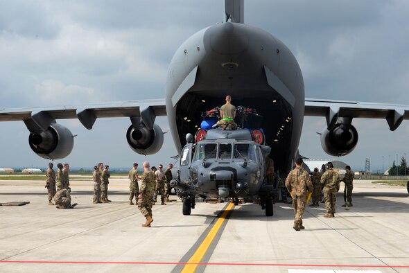 Maintainers from the 56th Helicopter Maintenance Unit and logistics readiness specialist from the 31st Fighter Wing, load an HH-60G Pave Hawk helicopter into a C-17 Globemaster III, prior to a deployment, at Aviano Air Base, Italy, May 22, 2019.  The primary mission of the HH-60G Pave Hawk helicopter is to conduct day or night personnel recovery operations into hostile environments to recover isolated personnel during war. (U.S. Air Force photo by Airman 1st Class Ericka A. Dechane).