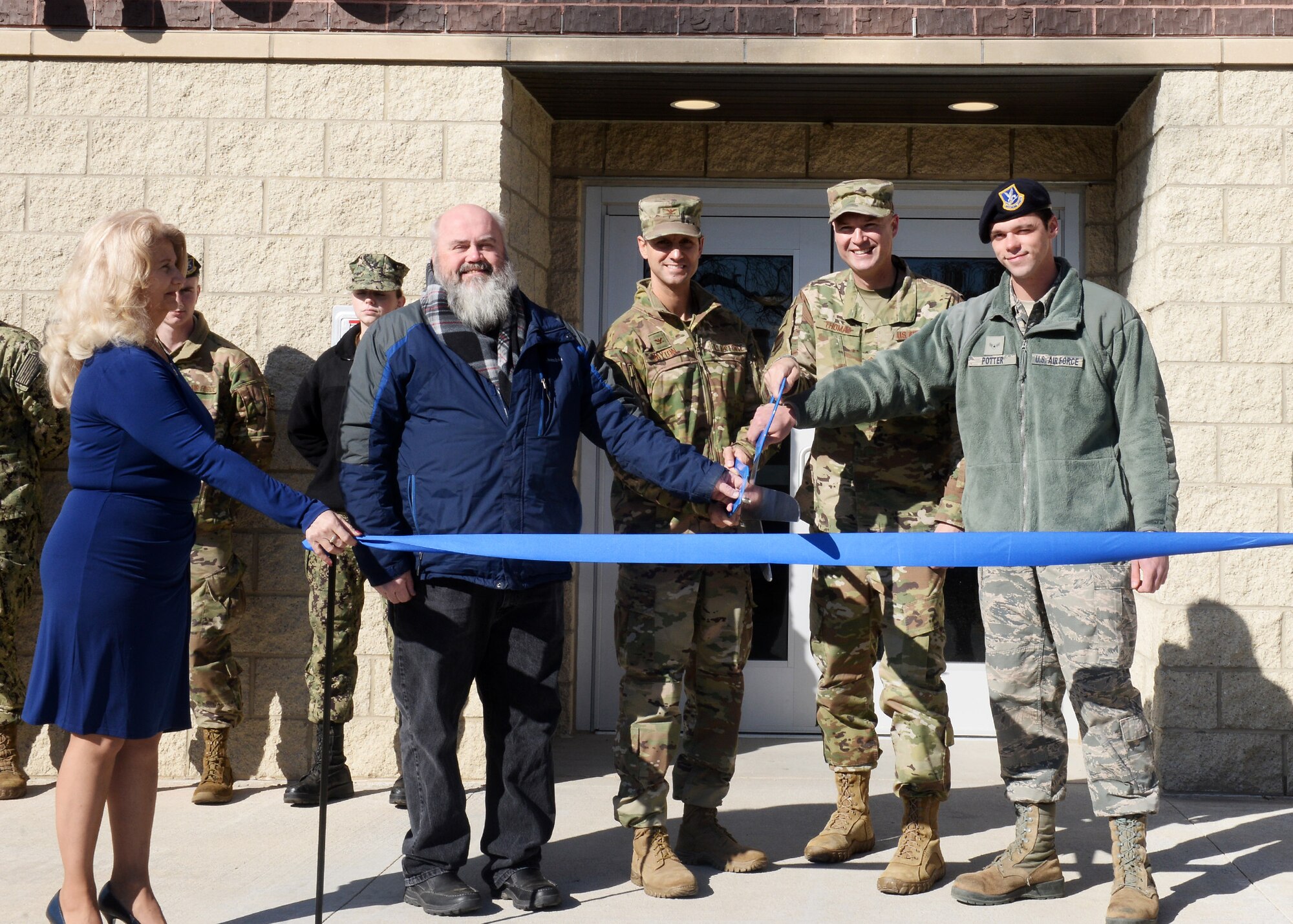 From left to right: Doug Shapland, 55th Civil Engineer Squadron project manager, Col. William Dayton, 55th Mission Support Group commander, Chief Master Sgt. Brian Thomas, 55th Wing command chief and Airman 1st Class Shane Potter, 55th Security Forces Squadron patrolman, cut a ribbon to mark the opening of Cobb Hall, the installation’s newest dormitory, Nov. 7, 2019. The new 51,000 square foot, three-floor dormitory includes 30 module suites that can accommodate 120 Airmen. The new $18.8 million dormitory is named in honor of retired Chief Master Sgt. Lawrence A. Cobb.