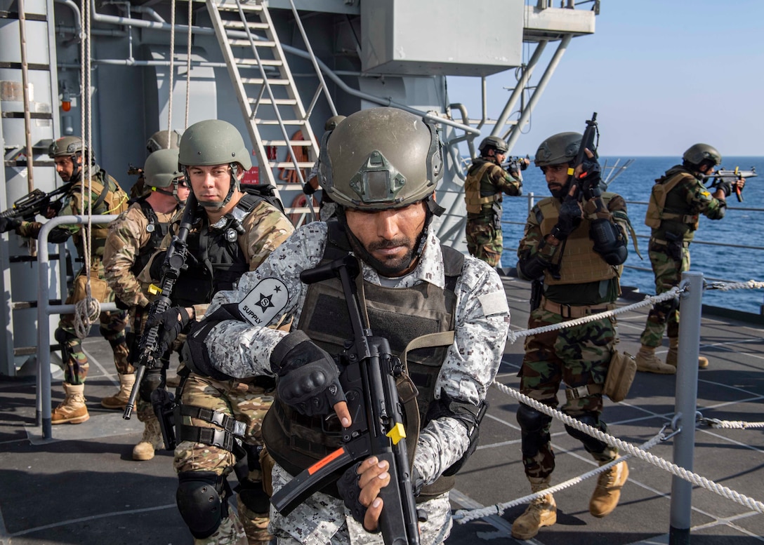 GULF OF OMAN (Nov. 6, 2019) Pakistan Navy sailors and members of the visit, board, search, and seizure (VBSS) team assigned to the guided-missile cruiser USS Normandy (CG 60) execute tactical movements as part of a VBSS drill during International Maritime Exercise 2019 (IMX 19). The exercise is a multinational engagement involving partners and allies from around the world designed to facilitate the sharing of knowledge and experiences across the full spectrum of defensive maritime operations. IMX 19 serves to demonstrate the global resolve in maintaining regional security and stability, freedom of navigation and the free flow of commerce from the Suez Canal south to the Bab el-Mandeb Strait through the Strait of Hormuz to the Northern Arabian Gulf. (U.S. Navy photo by Mass Communication Specialist 2nd Class Michael H. Lehman)