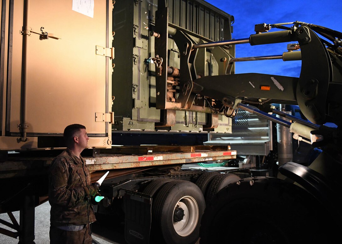 People stand with cargo.