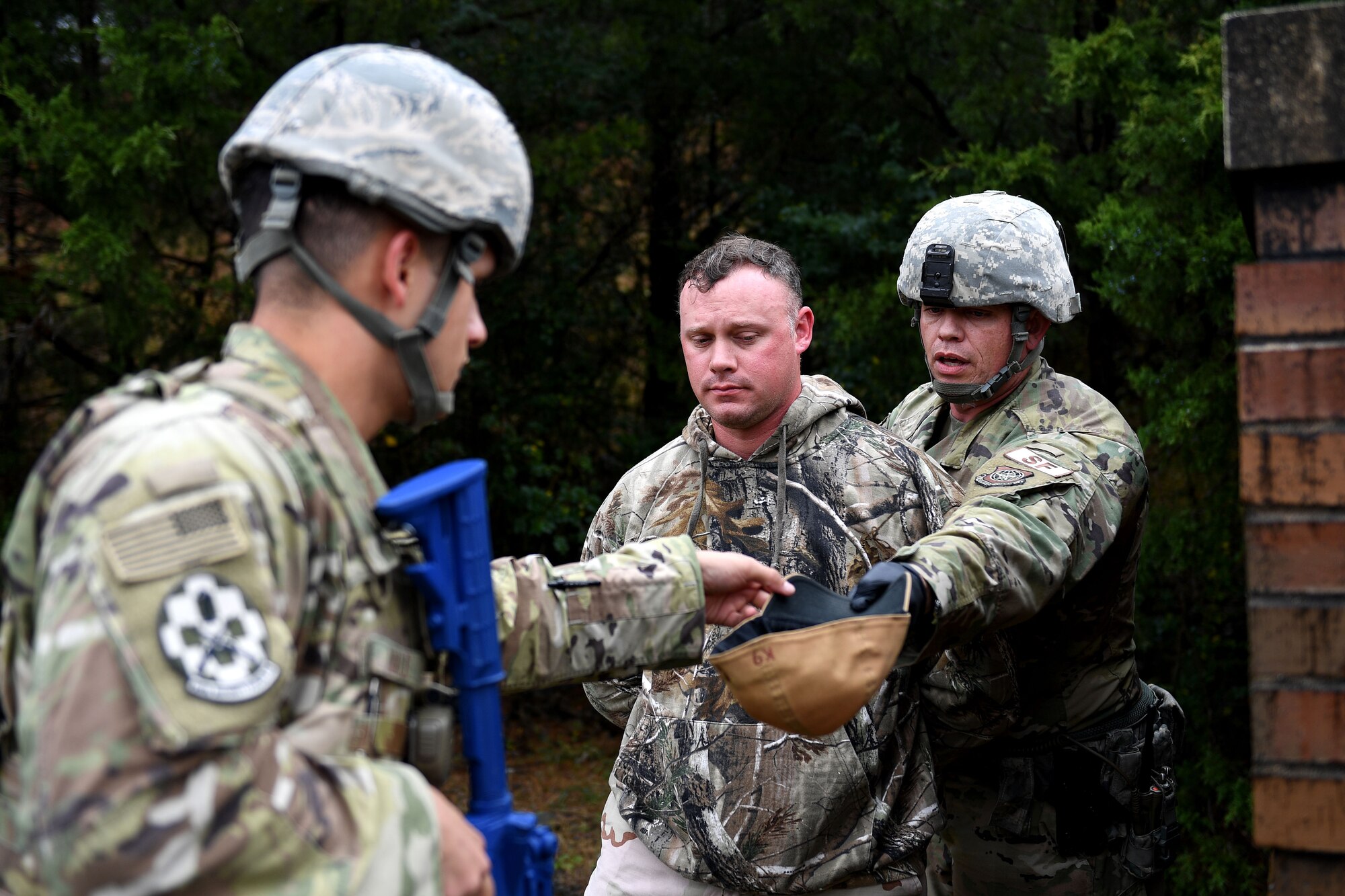 Men in uniform hold weapon.