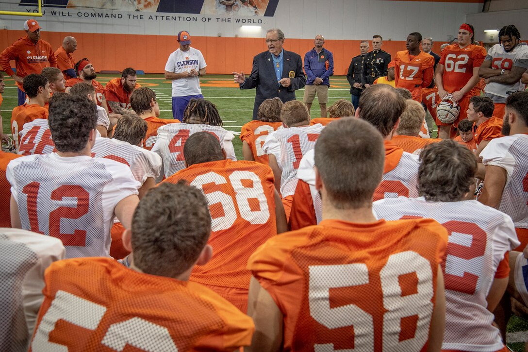 A Medal of Honor recipient speaks to a football team.