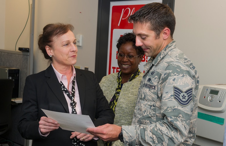 Erin O’Brien, National Air and Space Intelligence Center director of personnel, presents a certificate of recognition to Tech Sgt. Matthew Paine, Education and Training noncommissioned officer in charge, for his efforts in the face of adversity. On Paine’s drive home from work, Oct. 24, 2019 he noticed that an elder was in need of help, Paine he stopped to help a local citizen in need of help. (Photo by Tech. Sgt Benjamin Wiseman)