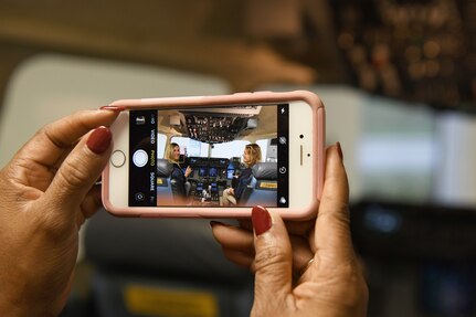 Shanda Johnson, Naval Information Warfare Center Atlantic S.T.E.M. outreach program director, takes a picture of educators with training equipment at Joint Base Charleston Nov. 7, 2019, as part of a continuing effort to strengthen collaboration between leaders from the base and local community.