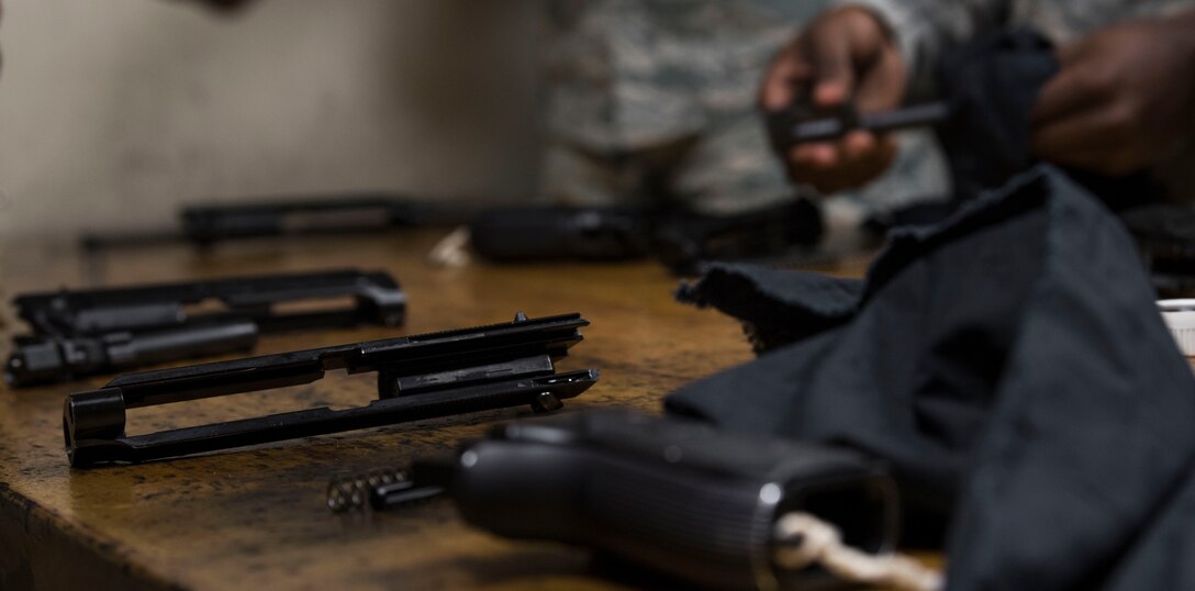 U.S. Air Force Airmen clean their weapons after participating in an inaugural M9 Excellence in Competition shooting event at the Combat Arms range complex at Shaw Air Force Base, South Carolina, Nov. 4, 2019.