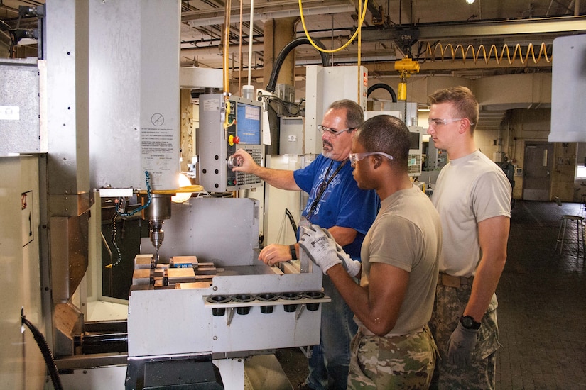 Workers operate machine