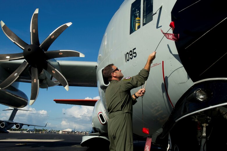 Lt. Col. Matthew Johnson, Joint Task Force-Support Forces Antarctica Joint Operations and Plans chief, removes a pin from an LC-130 Hercules on the flightline at Joint Base Pearl Harbor-Hickam, Hawaii, Oct. 31, 2019. The LC-130s are transiting from the Stratton Air National Guard Base in New York to the Joint Operating Area in Christchurch, New Zealand, and finally to the National Science Foundation’s McMurdo Station in Antarctica. The LC-130s fly to Antarctica in support of the NSF-managed U.S. Antarctic Program, as part of Operation DEEP FREEZE, the U.S. military’s contribution the civilian-managed USAP. (U.S. Air Force photo by Staff Sgt. Mikaley Kline)