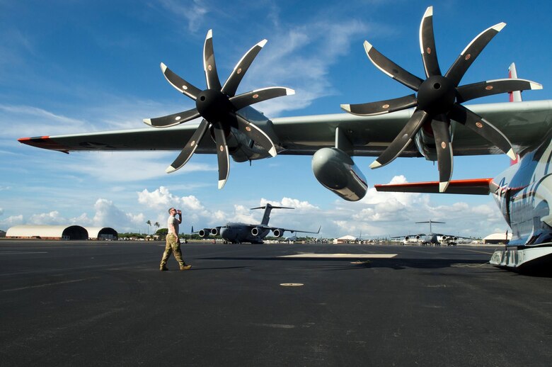 An Airman assigned to the 109th Airlift Wing, Stratton Air National Guard Base, New York, performs pre-flight inspections on the flightline at Joint Base Pearl Harbor-Hickam, Hawaii, Oct. 31, 2019. The LC-130s will be ferried to McMurdo Station, Antarctica, where they operate annually for six months as part of Operation DEEP FREEZE, which provides logistical support to the National Science Foundation-managed U.S. Antarctic Program (USAP). The USAP works closely with other Antarctic programs to include those of New Zealand, Australia and Italy, as well as their respective defense forces. (U.S. Air Force photo by Staff Sgt. Mikaley Kline)