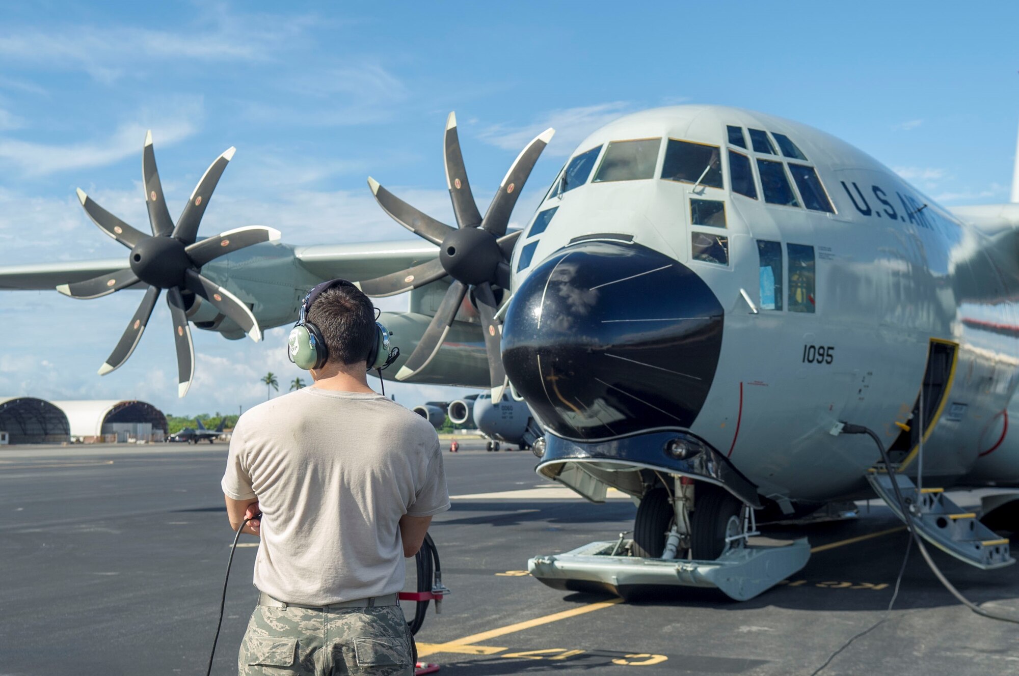 An Airman assigned to the 109th Airlift Wing, Stratton Air National Guard Base, New York, observes a LC-130 Hercules during pre-flight inspections on the flightline at Joint Base Pearl Harbor-Hickam, Hawaii, Oct. 31, 2019. The 2018-2019 Operation DEEP FREEZE season saw the first fully operational deployment of a U.S. Air Force LC-130H fleet modified with new propellers. The new propeller system has helped improve takeoff performance. Operation DEEP FREEZE is the U.S. military’s contribution to the National Science Foundation-managed U.S. Antarctic Program.  (U.S. Air Force photo by Staff Sgt. Mikaley Kline)