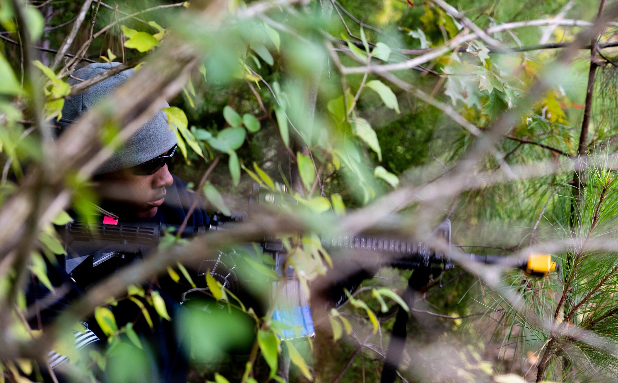 Airman 1st Class Jaonte Horden, 375th Security Forces Squadron entry controller, simulates an enemy attack during a mobility exercise at Scott Air Force Base, Ill., Nov. 6, 2019. During the simulated attack, two Airmen posed as enemies to give Airmen a chance to practice combat operations. (U.S. Air Force photo by Senior Airman Tara Stetler)