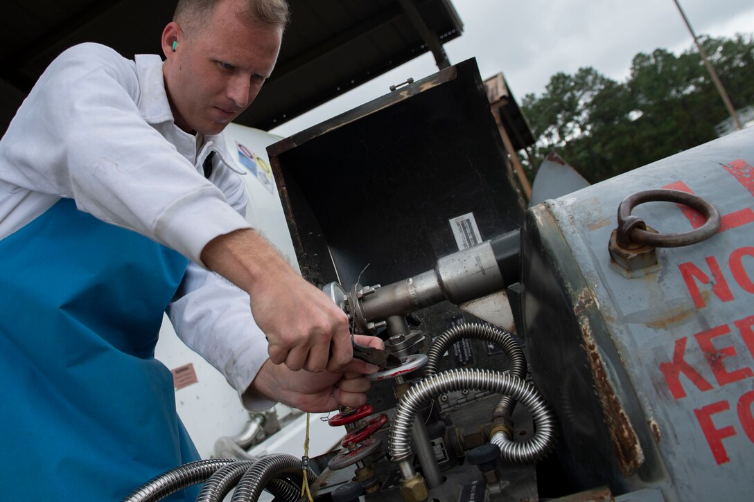 Staff Sgt. Bryan White, 23d Logistics Readiness Squadron (LRS) fuels facilities NCO in charge, removes safety wiring to fill a tank with liquid oxygen (LOX) Oct. 30, 2019, at Moody Air Force Base, Ga. LOX is used as a continuous supply of breathable air to pilots and aircrew at high altitudes. The 23d LRS fuels facilities Airmen fill tanks, take samples of LOX and conduct odor tests to evaluate its purity. (U.S. Air Force photo by Airman Azaria E. Foster)