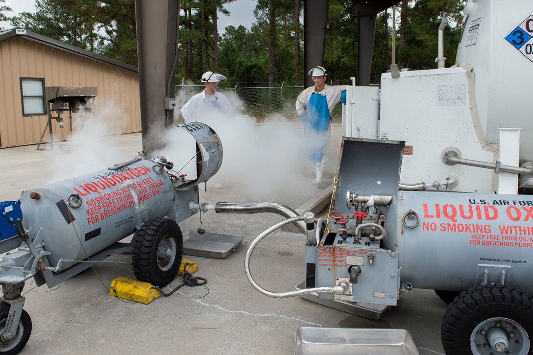 Staff Sgt. Bryan White, left, 23d Logistics Readiness Squadron (LRS) fuels facilities NCO in charge, and Senior Airman Gavin Rees, 23d LRS fuels facilities technician, watch tanks fill up with liquid oxygen (LOX) Oct. 30, 2019, at Moody Air Force Base, Ga. LOX is used as a continuous supply of breathable air to pilots and aircrew at high altitudes. The 23d LRS fuels facilities Airmen fill tanks, take samples of LOX and conduct odor tests to evaluate its purity. (U.S. Air Force photo by Airman Azaria E. Foster)