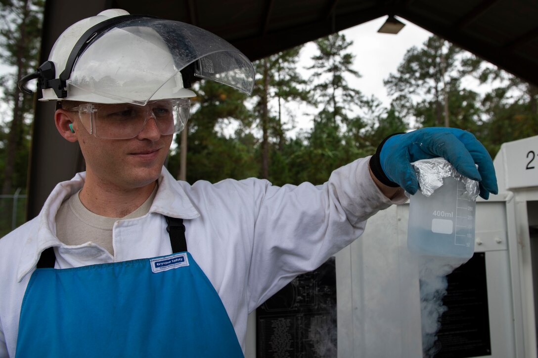Staff Sgt. Bryan White, 23d Logistics Readiness Squadron (LRS) fuels facilities NCO in charge, observes a sample of liquid oxygen (LOX) Oct. 30, 2019, at Moody Air Force Base, Ga. LOX is used as a continuous supply of breathable air to pilots and aircrew at high altitudes. The 23d LRS fuels facilities Airmen fill tanks, take samples of LOX and conduct odor tests to evaluate its purity. (U.S. Air Force photo by Airman Azaria E. Foster)