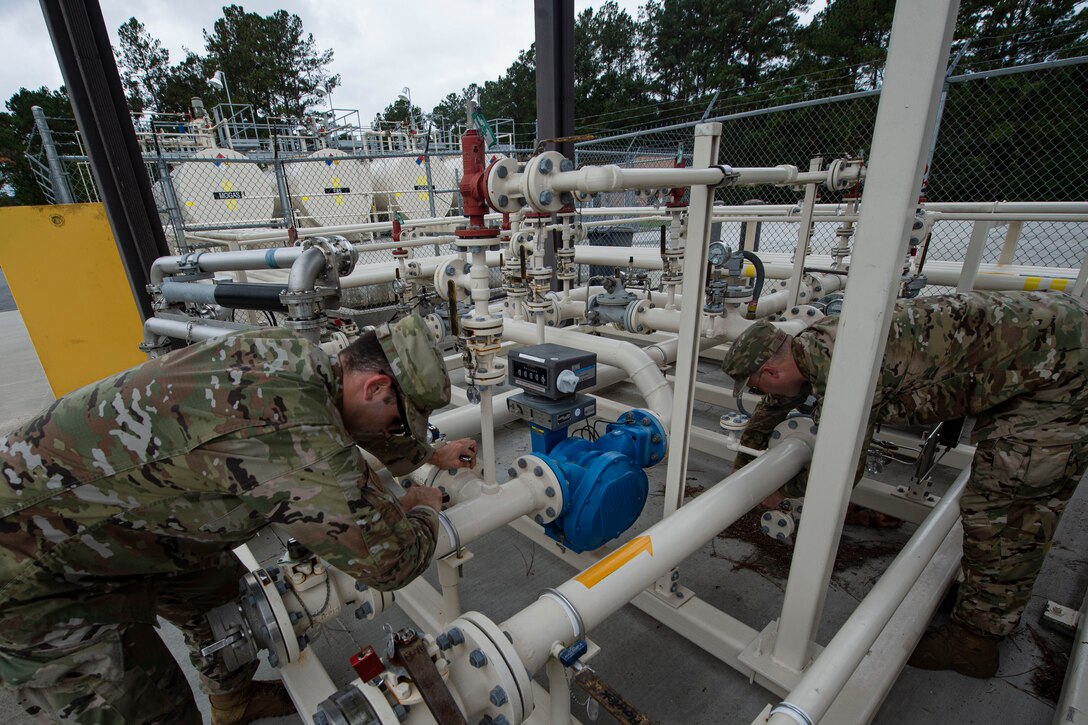 Senior Airman Gavin Rees, left, 23d Logistics Readiness Squadron (LRS) fuels facilities technician, and Staff Sgt. Bryan White, 23d LRS fuels facilities NCO in charge, check operating valves Oct. 30, 2019, at Moody Air Force Base, Ga. The 23d LRS fuels facilities is responsible for maintaining facilities, product purity, storage and accountability. Fuels facilities Airmen maintain the base service station by performing routine checks on the operating valves, fuel tanks and service station parts. (U.S. Air Force photo by Airman Azaria E. Foster)