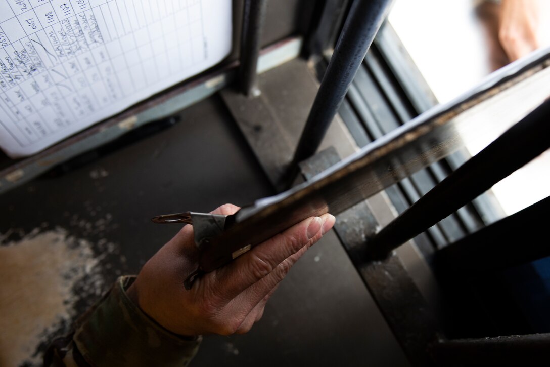 Tech. Sgt. Carl Slater, 23d Maintenance Squadron senior munitions controller, gives a visitor a register log to sign Nov. 7, 2019, at Moody Air Force Base, Ga. The Munitions Flight Systems Division is responsible for maintaining the security of ‘Ammo Country’ as well as tracking munitions and orders from around Moody. Airmen assigned to this division control security gates, escort visitors and communicate with flying squadrons to determine munitions needs. (U.S. Air Force photo by Airman Elijah M. Dority)