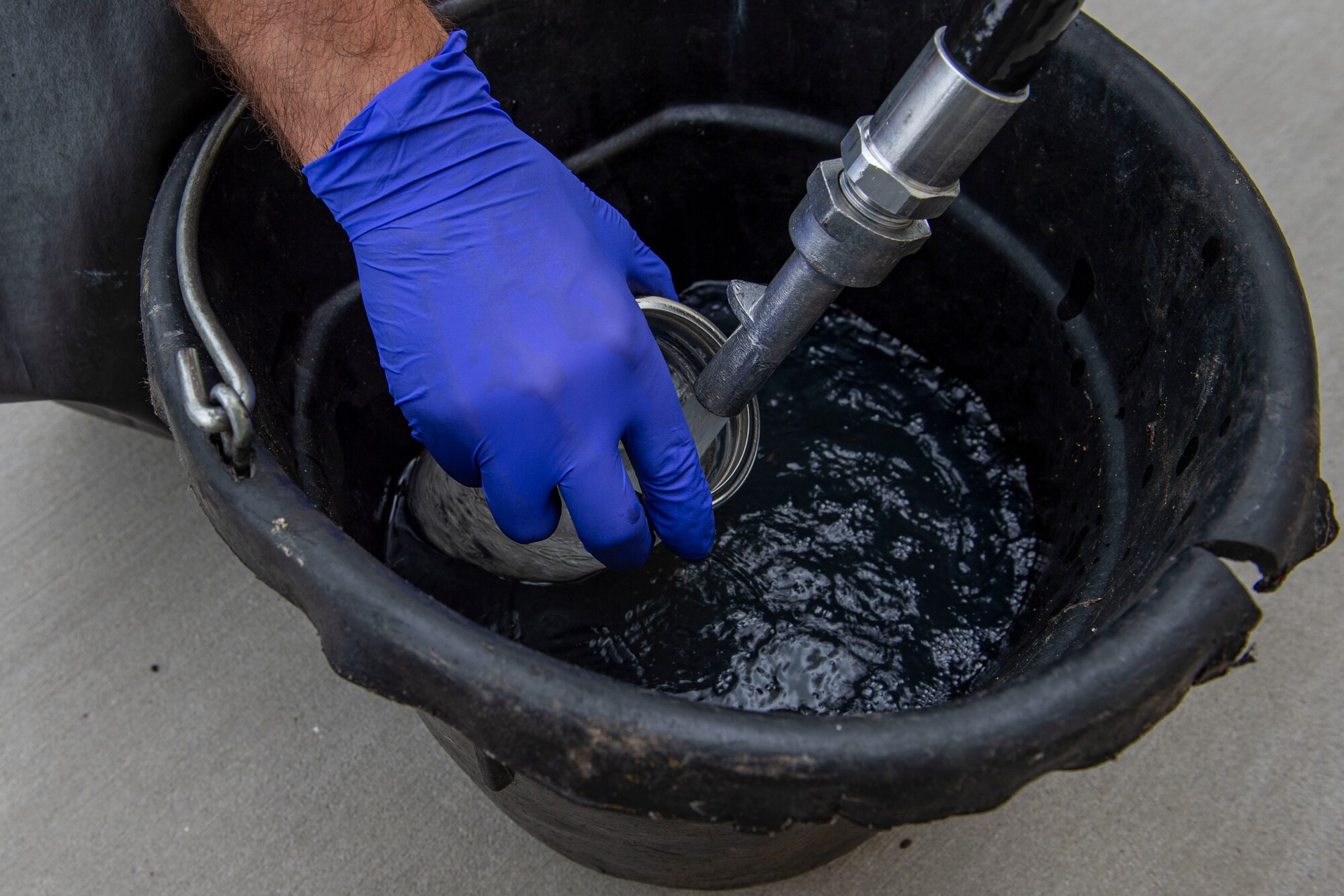 A photo of an Airman draining tank sumps of fuel