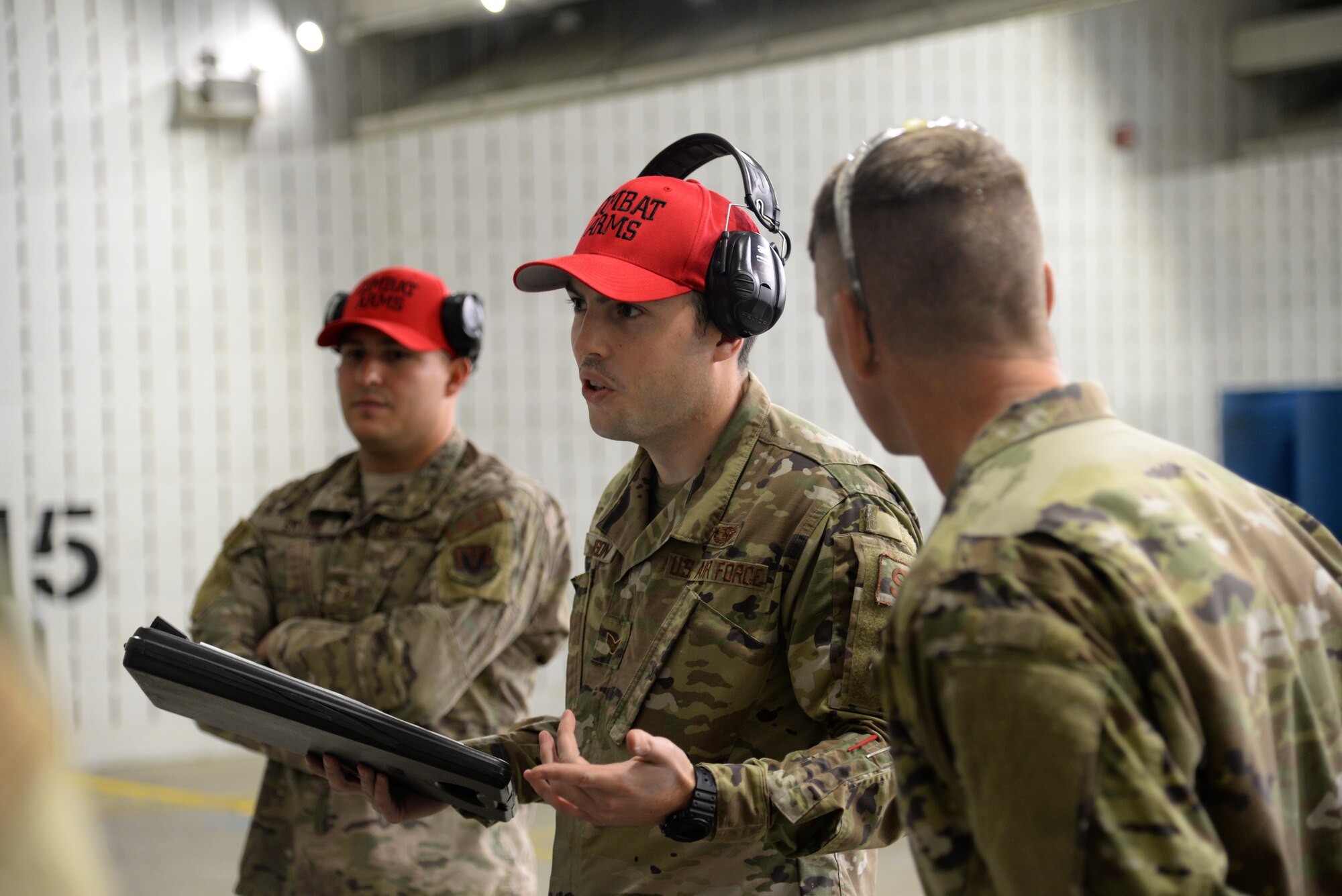 A picture of U.S. Air Force Senior Airman Zachary Ferguson, an Airman with the 177th Fighter Wing Security Forces Squadron, talking to the wing commander and group commanders of the 177FW.