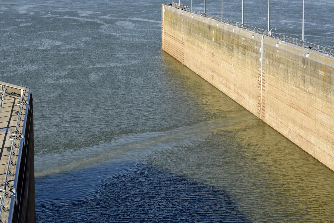Bubbles reach the surface of the Cumberland River on the downstream side of Barkley Lock in Grand Rivers, Ky., during a commissioning ceremony for a bio-acoustic fish fence Nov. 8, 2019. The BAFF sends a curtain of bubbles, sound and light from the riverbed to the water surface, which deters noise-sensitive Asian carp from entering the lock chamber. Fisheries managers on the west coast of the United States use a similar system to guide the movement of trout and salmon from water channels. This marks the first time a BAFF has been tested at a lock and dam on a large river. Construction of the BAFF began in July 2019. The project involves multiple partners, including U.S. Fish and Wildlife Service, Kentucky Department of Fish and Wildlife Resources, U.S. Army Corps of Engineers Nashville District, U.S. Geological Survey, and Tennessee Wildlife Resources Agency. Fish Guidance Systems, a United Kingdom-based company specializing in fish deflection and guidance systems, provided the BAFF technology at Barkley Lock.  (USACE photo by Lee Roberts)