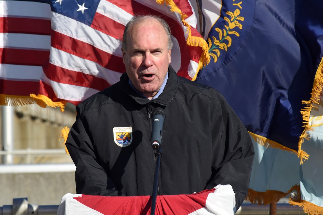 Charles Wooley, U.S. Fish and Wildlife Service Great Lakes Region 3 director, speaks during a commissioning ceremony for a bio-acoustic fish fence Nov. 8, 2019 below Barkley Lock in Grand Rivers, Ky. The BAFF sends a curtain of bubbles, sound and light from the riverbed to the water surface, which deters noise-sensitive Asian carp from entering the lock chamber. Fisheries managers on the west coast of the United States use a similar system to guide the movement of trout and salmon from water channels. This marks the first time a BAFF has been tested at a lock and dam on a large river. Construction of the BAFF began in July 2019. The project involves multiple partners, including U.S. Fish and Wildlife Service, Kentucky Department of Fish and Wildlife Resources, U.S. Army Corps of Engineers Nashville District, U.S. Geological Survey, and Tennessee Wildlife Resources Agency. Fish Guidance Systems, a United Kingdom-based company specializing in fish deflection and guidance systems, provided the BAFF technology at Barkley Lock.  (USACE photo by Lee Roberts)