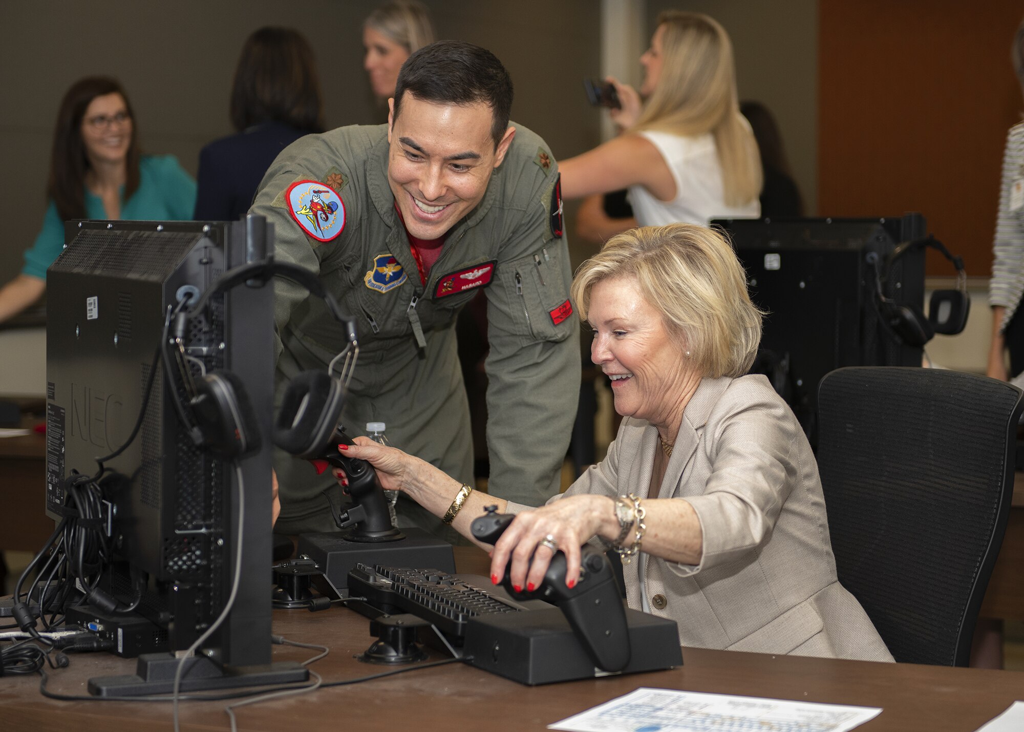 Maj. Justin Lee, 56th Training Squadron instructor pilot, shows Dawn Goldfien, wife of Air Force Chief of Staff Gen. David L. Goldfein, how to operate an F-35A Lightning II simulator at Luke Air Force Base, Ariz., Nov. 8, 2019.