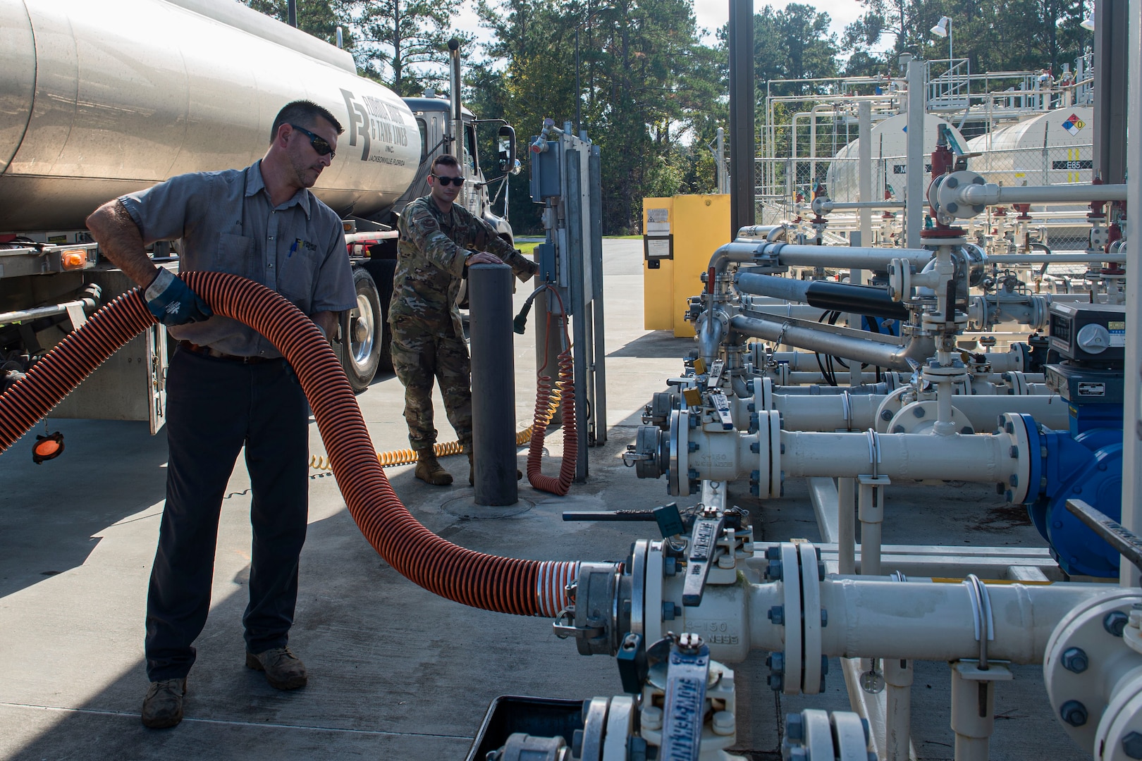 Brent Deas, Florida Rock & Tank Lines Incorporated truck driver, holds a hose while refueling tanks Nov. 6, 2019, at Moody Air Force Base, Ga. The 23d LRS fuels facilities is responsible for maintaining facilities, product purity, storage and accountability. Fuels facilities Airmen maintain the base service station by performing routine checks on the operating valves, fuel tanks and service station parts. (U.S. Air Force photo by Airman Azaria E. Foster)