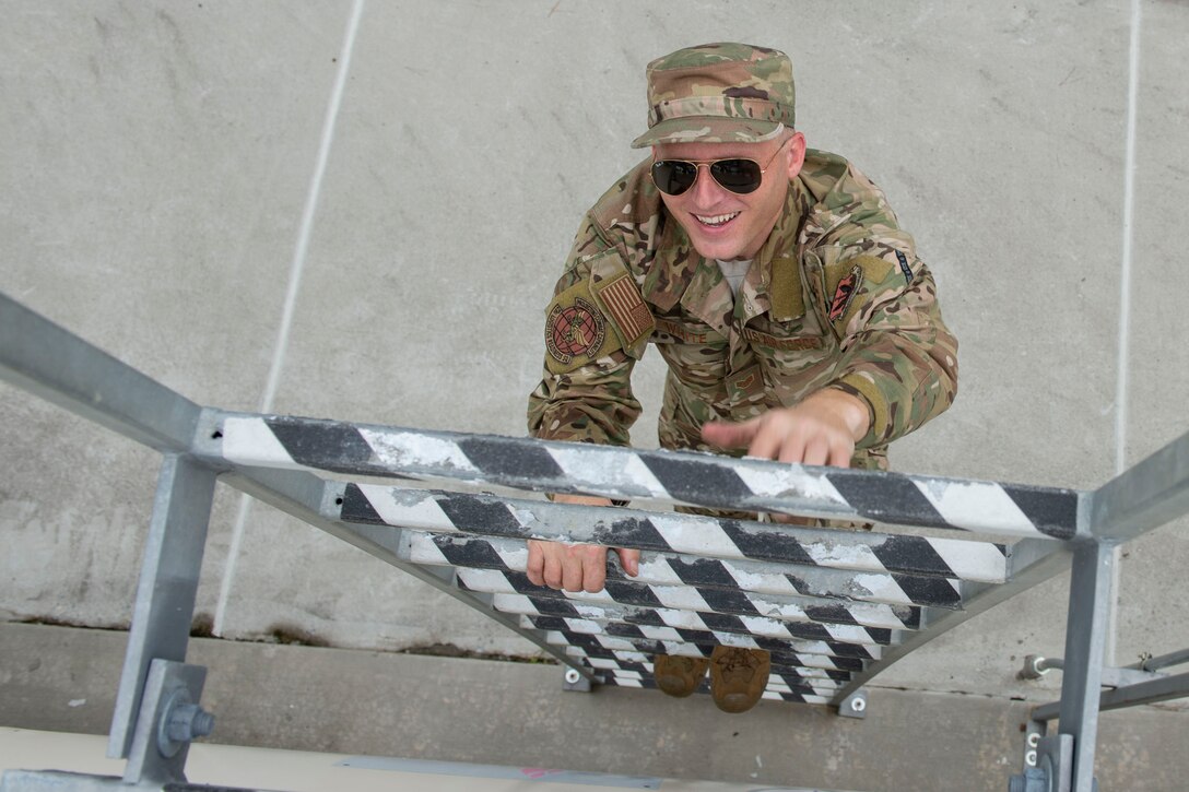 Staff Sgt. Bryan White, 23d Logistics Readiness Squadron (LRS) fuels facilities NCO in charge, climbs a ladder Oct. 30, 2019, at Moody Air Force Base, Ga. The 23d LRS fuels facilities is responsible for maintaining facilities, product purity, storage and accountability. Fuels facilities Airmen maintain the base service station by performing routine checks on the operating valves, fuel tanks and service station parts. (U.S. Air Force photo by Airman Azaria E. Foster)