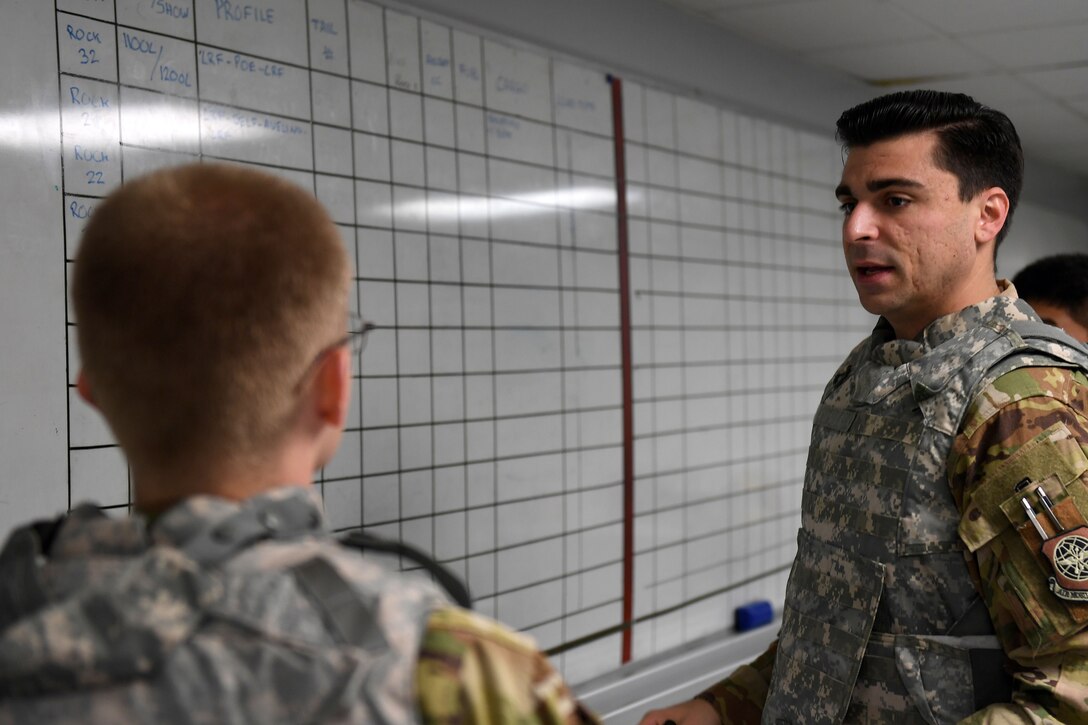 A man talks to another man.