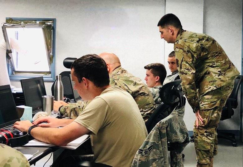 Members of the 552nd Air Control Networks Squadron participate in the Air Force's first mission qualification training course for mission defense teams in Oct. 2019. Nine 552nd ACNS members graduated this course, qualifying them to be operators on the Cyberspace Vulnerability Assessment/Hunter Weapon System.