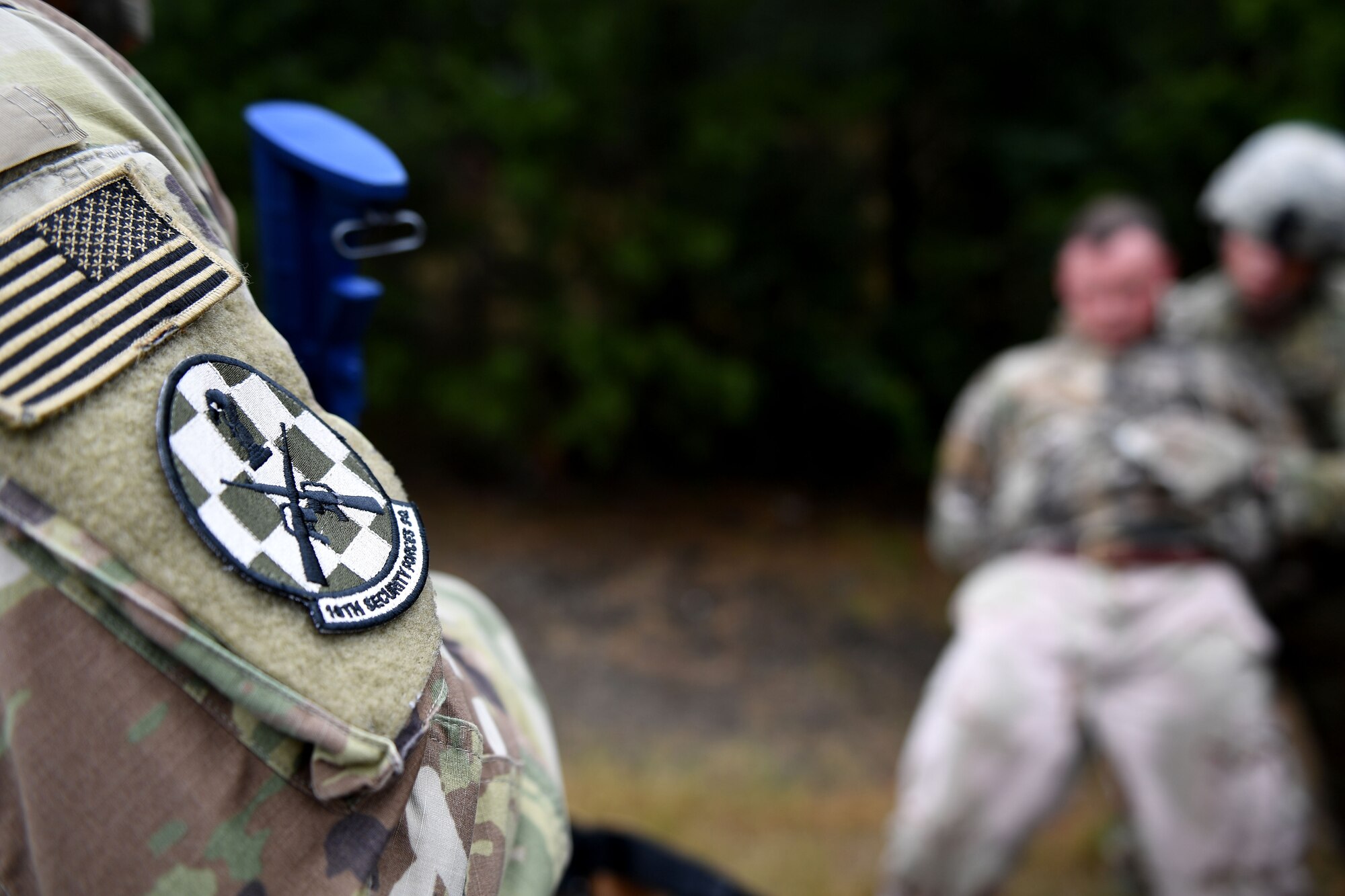Men in uniform hold weapon
