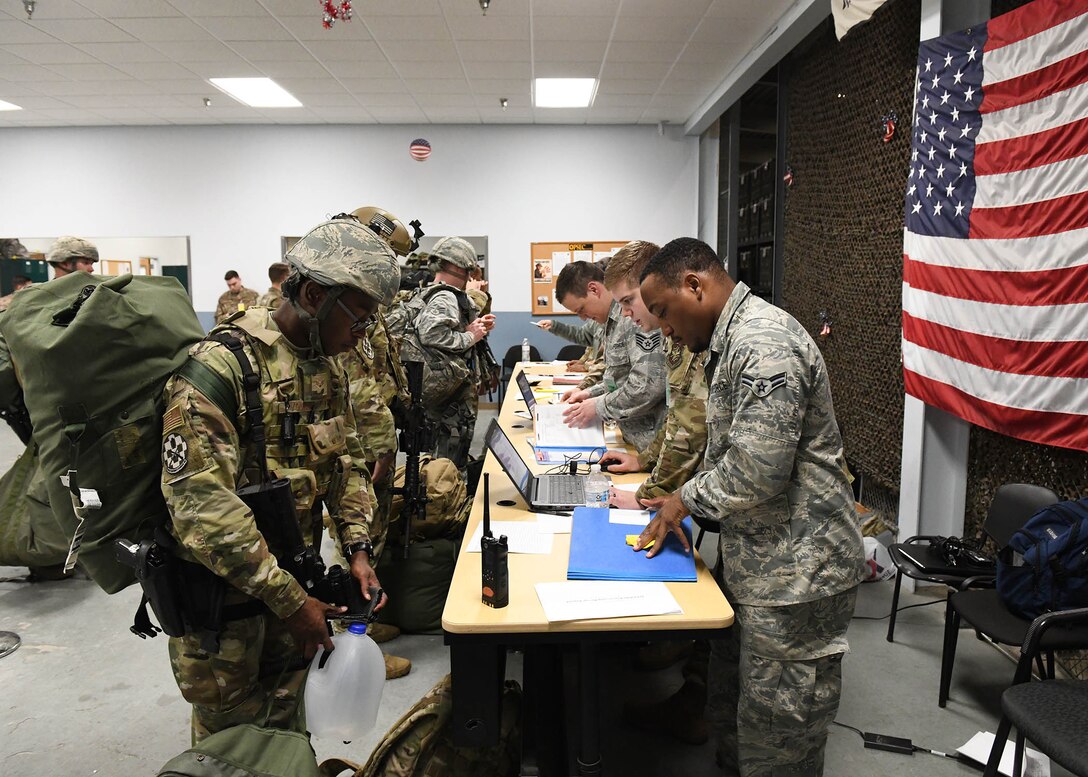 People in uniform wait in line.