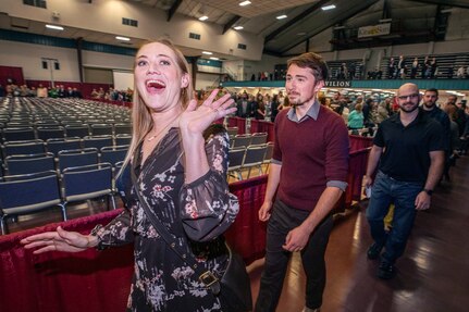 Shop 51 marine electrician Lindsay Noah, left, waves to friends and family members as she and her classmates enter the auditorium during 2019 PSNS & IMF Apprentice Graduation ceremony Friday, Nov. 8 at the Kitsap County Fairgrounds Kitsap Sun Pavilion.