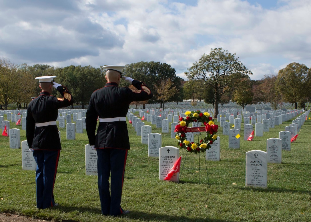 Sergeant Major of the Marine Corps Sgt. Maj. Troy E. Black, right, and Sgt. Maj. Adrian L. Tagliere salute after placing a wreath on the grave of Master Sgt. Catherine Grace Murray during a private ceremony Nov. 8 at Arlington National Cemetery. Murray, the first woman to retire from the Marine Corps, was one of three veterans who were remembered during the annual wreath-laying ceremony.