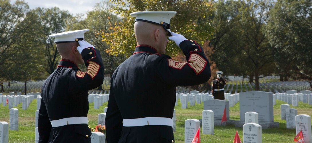 Sergeant Major of the Marine Corps Sgt. Maj. Troy E. Black, right, and Sgt. Maj. Adrian L. Tagliere salute after laying a wreath on the grave of Master Sgt. Catherine Grace Murray during a private ceremony Nov. 8 at Arlington National Cemetery. Murray, the first woman to retire from the Marine Corps, was one of three veterans who were remembered during the annual wreath-laying ceremony.