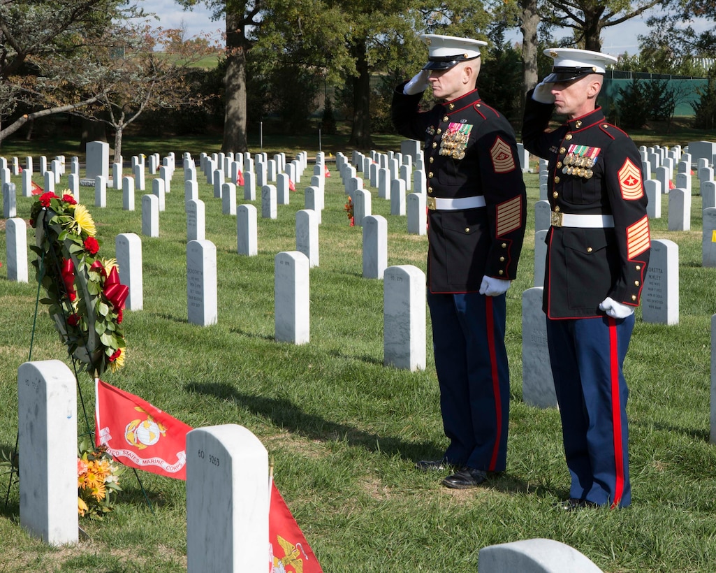 Sergeant Major of the Marine Corps Sgt. Maj. Troy E. Black, right, and Sgt. Maj. Adrian L. Tagliere stand at attention after placing a wreath on the grave of Sgt. Ronald Ariel Rodriguez during a private ceremony Nov. 8 at Arlington National Cemetery. Rodriguez, who died Aug. 23, 2010, while supporting combat operations in Helmand province, Afghanistan, was one of three veterans who were remembered during the annual wreath-laying ceremony.
