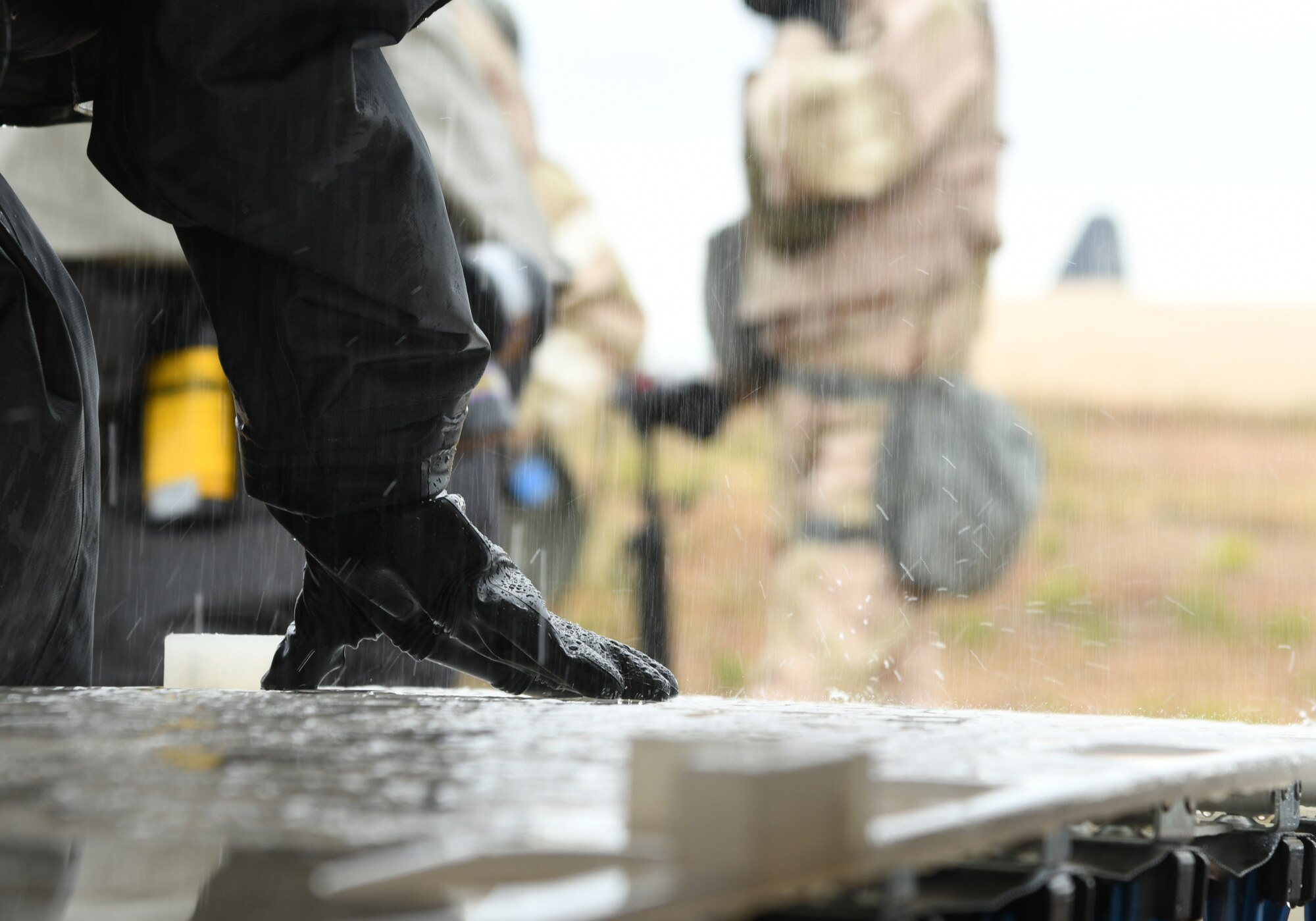 a photo of airmen working and wearing MOPP gear during an exercise