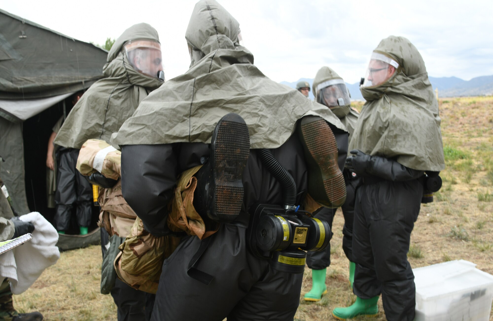 U.S. Air Force Airmen carry a victim from a simulated chemical attack to a decontamination tent during Exercise Bushwhacker 19-08 at Libby Army Airfield, Arizona, Nov. 6, 2019.