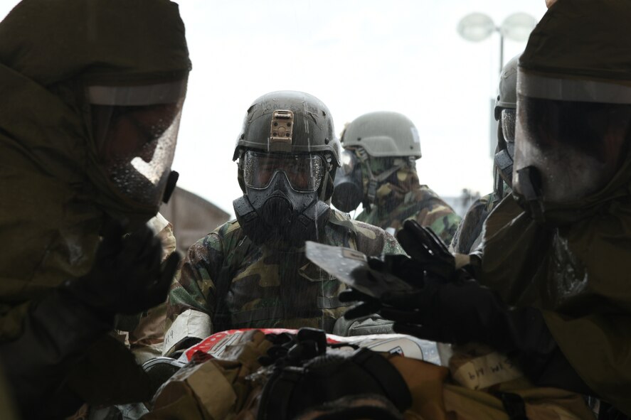 U.S. Air Force Airmen carry a victim from a simulated chemical attack to a decontamination tent during Exercise Bushwhacker 19-08 at Libby Army Airfield, Arizona, Nov. 6, 2019.